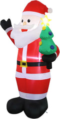 Santa inflatable waving and holding a small green Christmas tree