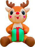 Giant cartoon reindeer inflatable sitting and holding a green gift box