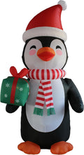 Tall penguin inflatable in a Santa hat and striped scarf holding a green gift