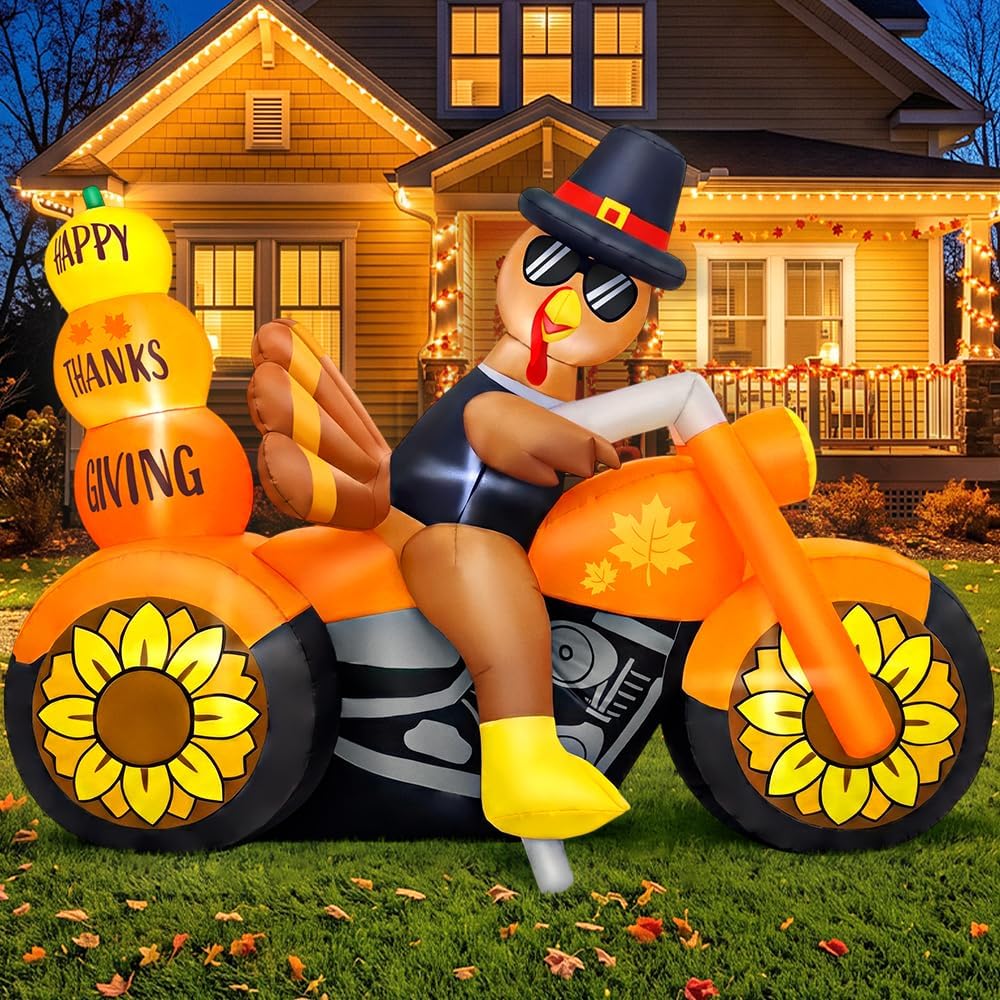 Turkey in sunglasses riding an orange motorcycle inflatable with sunflower wheels and Happy Thanksgiving pumpkins