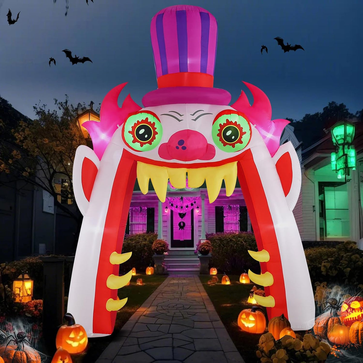 Tall clown face archway inflatable with a striped top hat and toothy mouth over a front walk