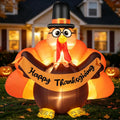 Turkey inflatable in glasses and a pilgrim hat holding a Happy Thanksgiving banner at dusk