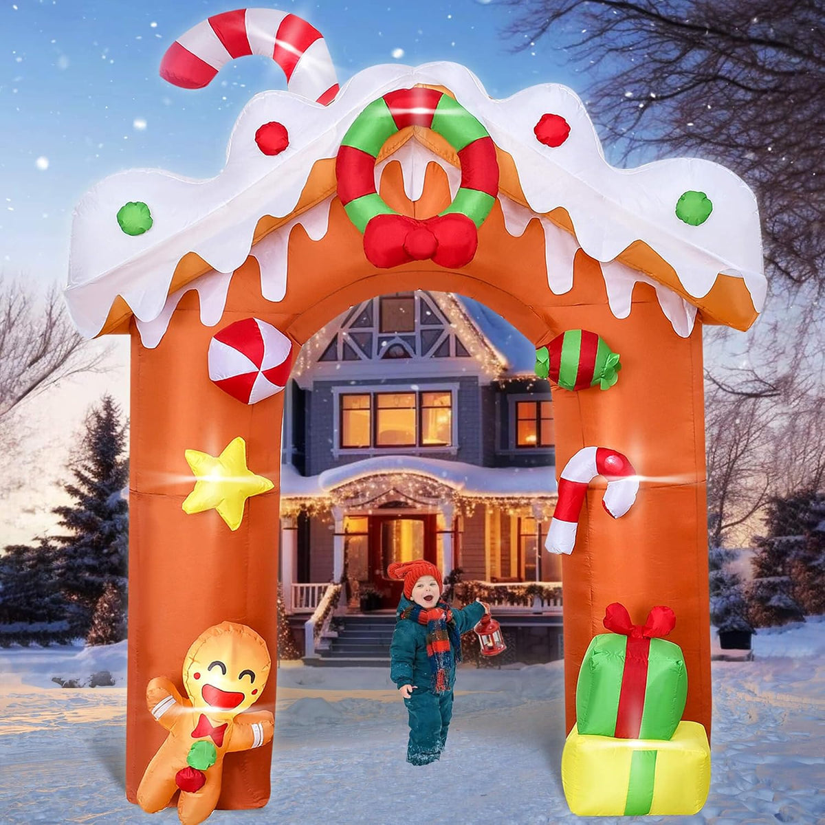 Gingerbread house arch inflatable with candy canes, a gingerbread man and a gift over a snowy walk