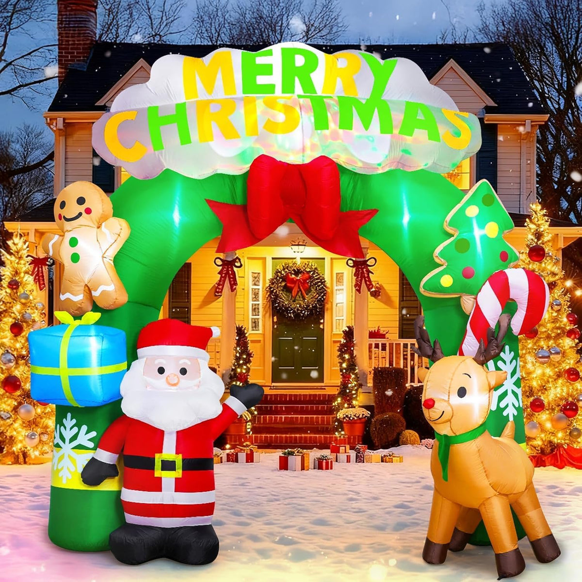 Green Merry Christmas arch inflatable with Santa, a reindeer and a gingerbread man in front of a lit house