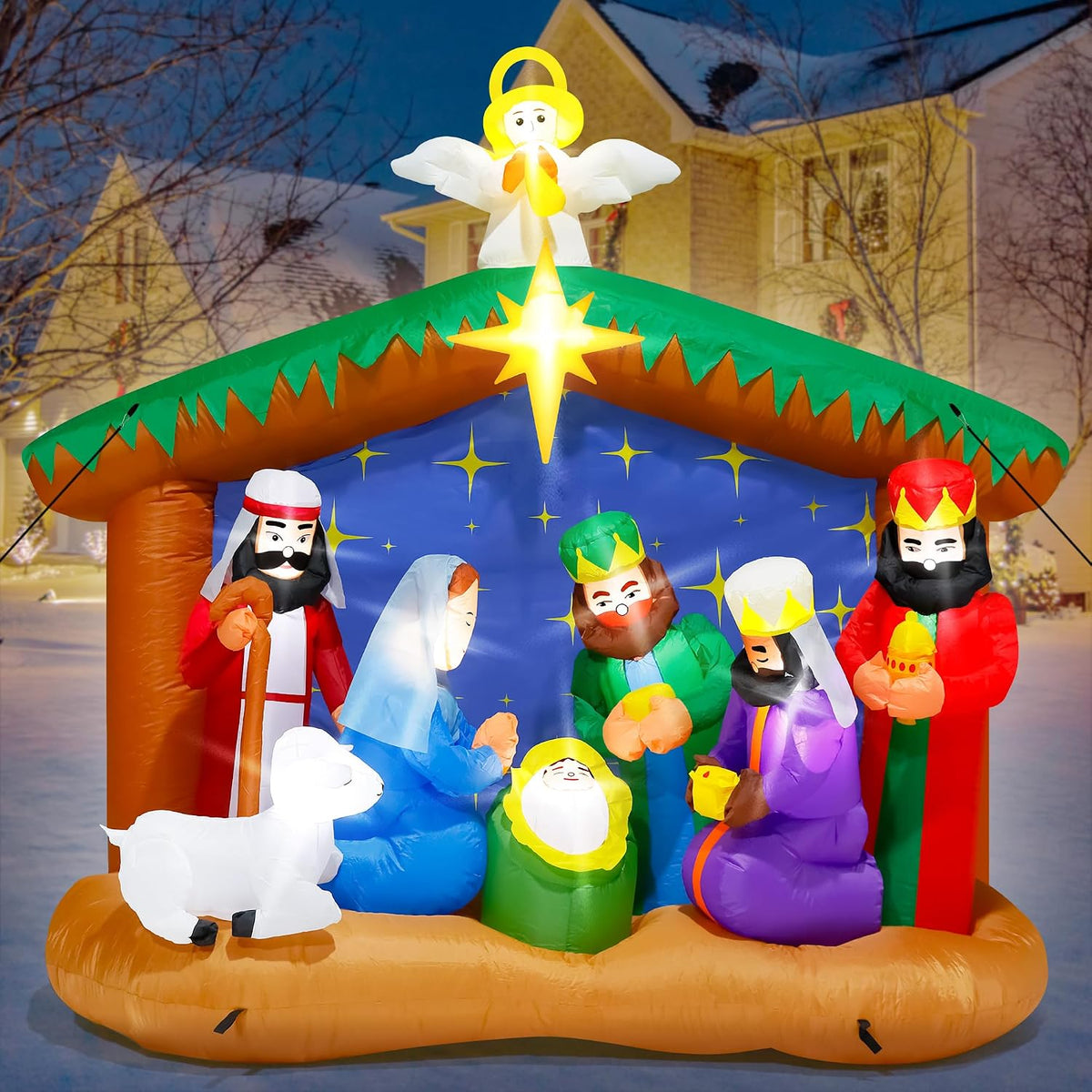 Nativity inflatable with the Holy Family, three kings, a lamb and an angel on the roof in a yard