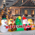 Lineup of a snowman, reindeer, tree, Santa and gingerbread behind a Merry Christmas banner inflatable